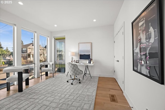 office space with recessed lighting, visible vents, baseboards, and wood finished floors