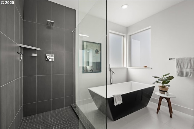 full bath featuring recessed lighting, baseboards, a freestanding bath, tile patterned floors, and walk in shower