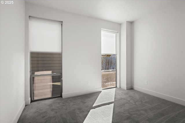 unfurnished bedroom featuring carpet and baseboards