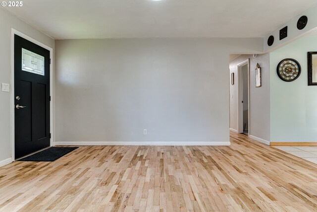 interior space with light tile patterned floors, a kitchen breakfast bar, tasteful backsplash, white cabinets, and french doors