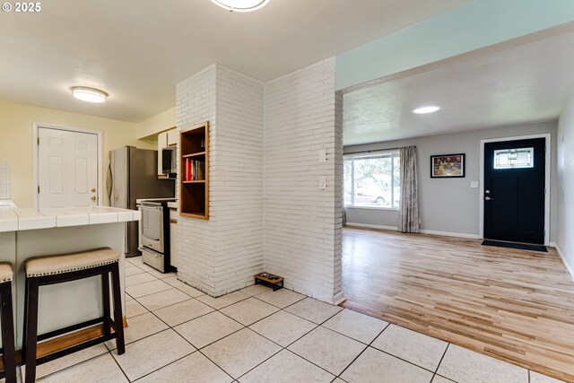 bathroom featuring tile patterned floors, toilet, wood ceiling, vanity, and decorative backsplash