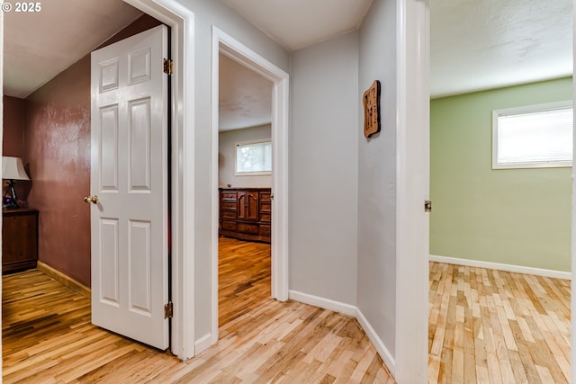 hallway with light hardwood / wood-style flooring