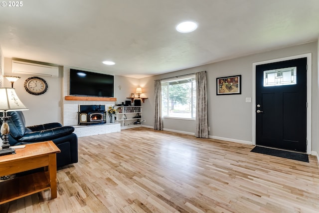 living room with light hardwood / wood-style flooring and a wall mounted AC