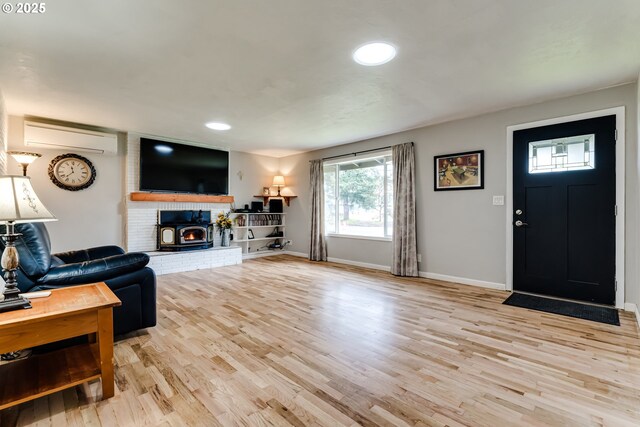 living room with hardwood / wood-style flooring, brick wall, and an AC wall unit