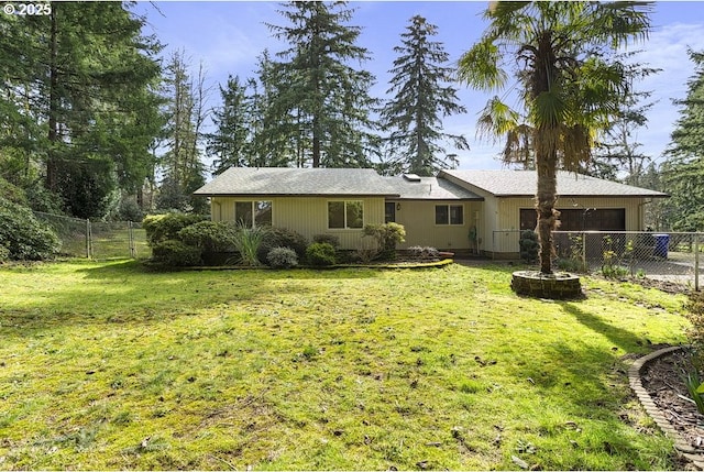 back of property with a garage, fence private yard, and a yard