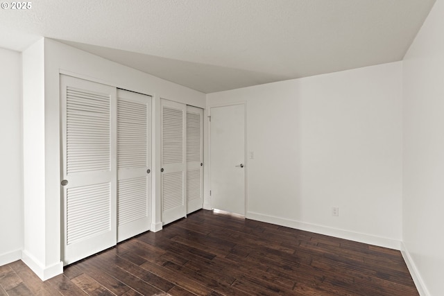 4844 SW Wembley Pl, Beaverton, OR 97005 - unfurnished bedroom featuring multiple closets and dark wood-style flooring