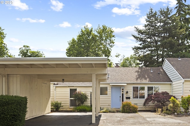 4844 SW Wembley Pl, Beaverton, OR 97005 - view of front facade featuring a carport and a chimney