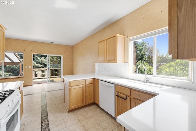 16917 SE Dunhill Loop, Damascus, OR 97089 - kitchen featuring white appliances, healthy amount of natural light, light tile patterned floors, and a peninsula