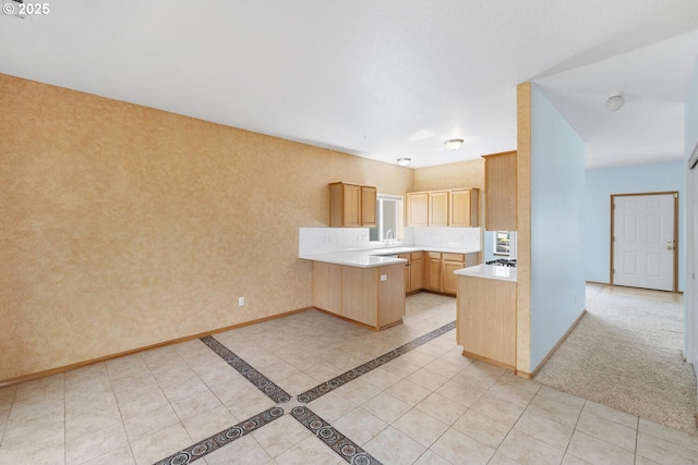 16917 SE Dunhill Loop, Damascus, OR 97089 - kitchen with a peninsula, light countertops, and light tile patterned floors