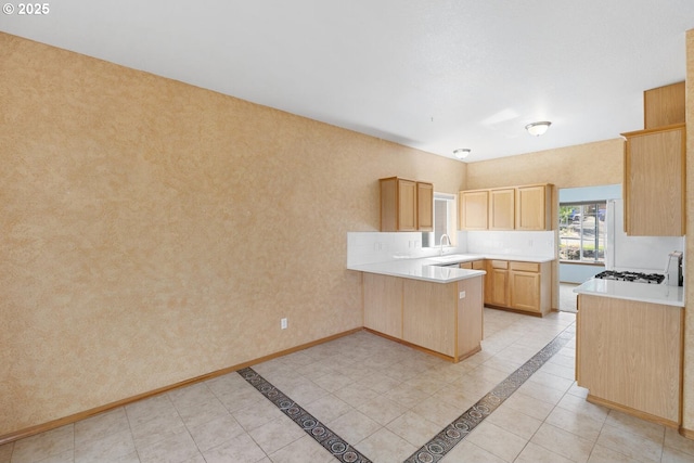 16917 SE Dunhill Loop, Damascus, OR 97089 - kitchen with a peninsula, light brown cabinets, light tile patterned floors, and light countertops