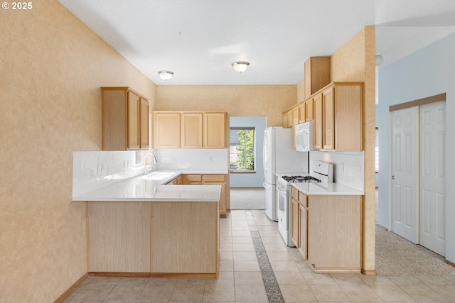16917 SE Dunhill Loop, Damascus, OR 97089 - kitchen featuring white appliances, light brown cabinets, light countertops, a peninsula, and decorative backsplash