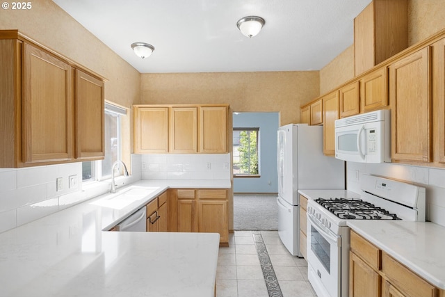 16917 SE Dunhill Loop, Damascus, OR 97089 - kitchen with white appliances, light countertops, light brown cabinetry, and light tile patterned floors