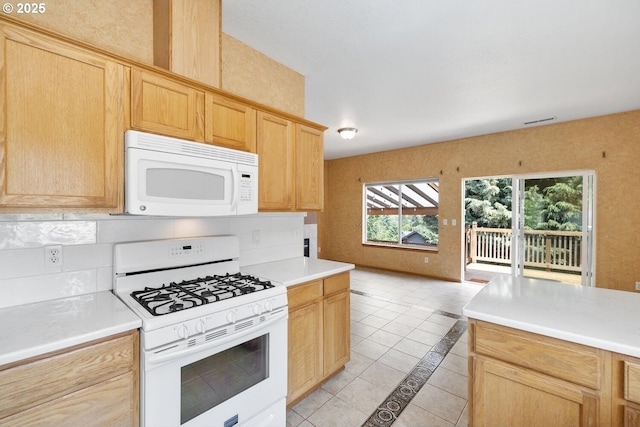 16917 SE Dunhill Loop, Damascus, OR 97089 - kitchen with white appliances, light brown cabinetry, inlaid floor details, light countertops, and light tile patterned floors