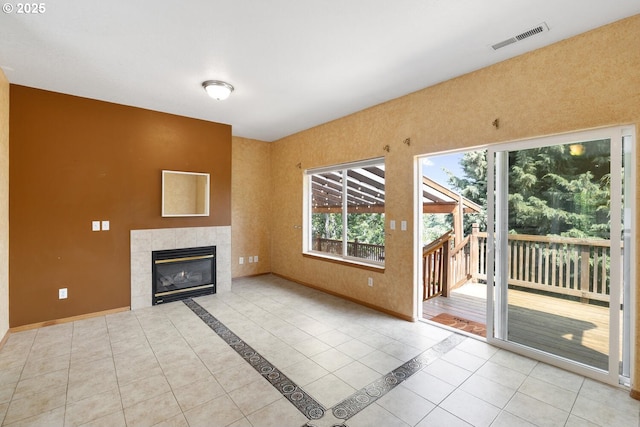 16917 SE Dunhill Loop, Damascus, OR 97089 - unfurnished living room with a tiled fireplace and tile patterned floors