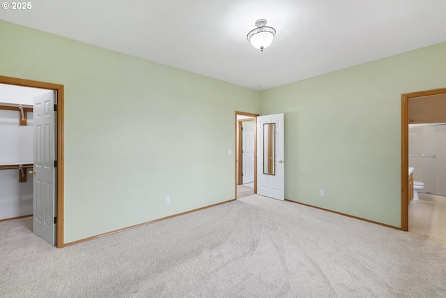 16917 SE Dunhill Loop, Damascus, OR 97089 - unfurnished bedroom with a walk in closet, carpet floors, a closet, and ensuite bath