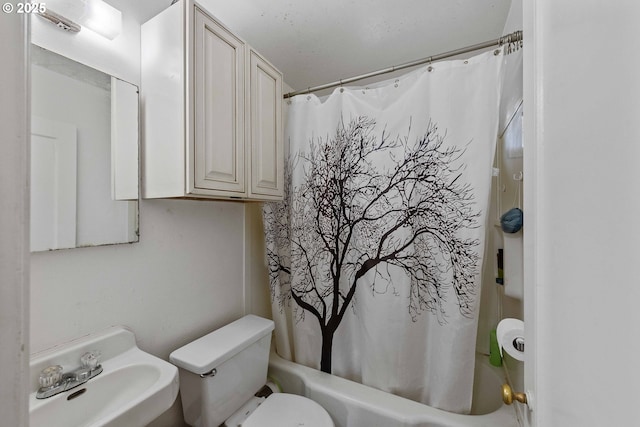 bathroom featuring a sink, toilet, and shower / bath combo with shower curtain
