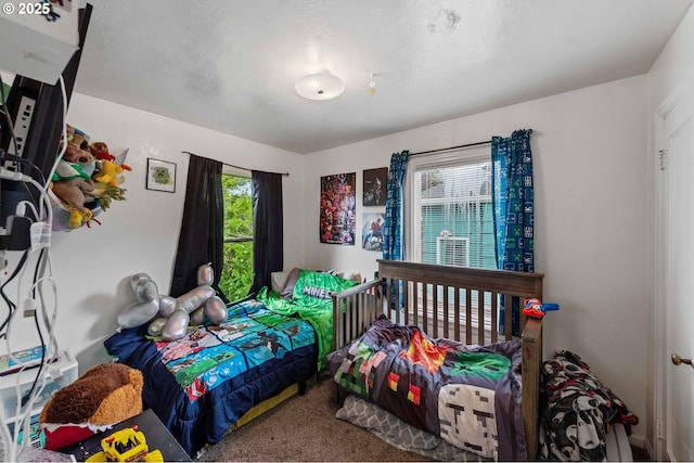 carpeted bedroom with a textured ceiling