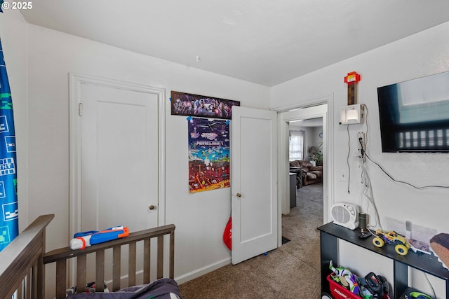 bedroom featuring carpet and baseboards