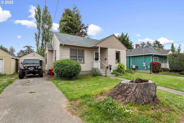 bungalow-style home featuring a garage, an outbuilding, a front yard, a chimney, and a shingled roof