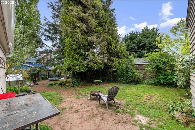 view of yard featuring an outdoor fire pit, a patio, and a fenced backyard