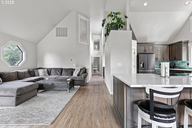 3430 Breezewood Ave, Eugene, OR 97405 - living room with vaulted ceiling, light wood finished floors, and recessed lighting