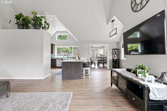 3430 Breezewood Ave, Eugene, OR 97405 - living area with high vaulted ceiling, light wood finished floors, recessed lighting, and baseboards