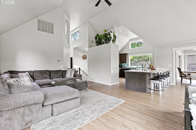 3430 Breezewood Ave, Eugene, OR 97405 - living room with high vaulted ceiling, a ceiling fan, and light wood-style flooring