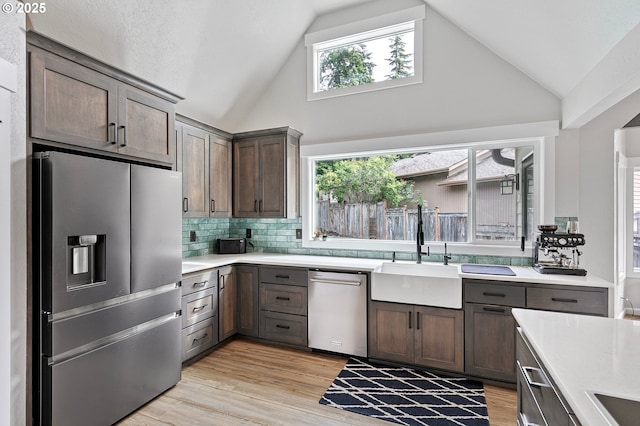 3430 Breezewood Ave, Eugene, OR 97405 - kitchen with stainless steel appliances, a sink, light countertops, tasteful backsplash, and high vaulted ceiling