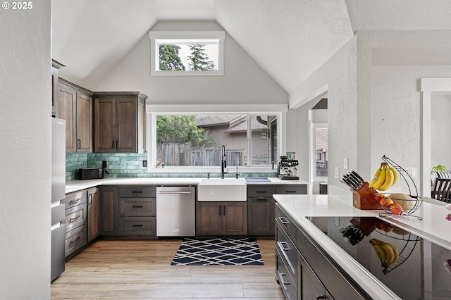 3430 Breezewood Ave, Eugene, OR 97405 - kitchen with stainless steel dishwasher, black electric cooktop, a sink, light countertops, and high vaulted ceiling