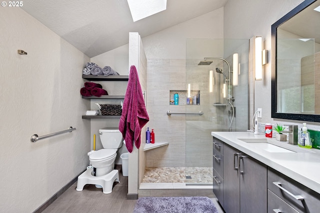 3430 Breezewood Ave, Eugene, OR 97405 - bathroom with vaulted ceiling, toilet, vanity, walk in shower, and a skylight