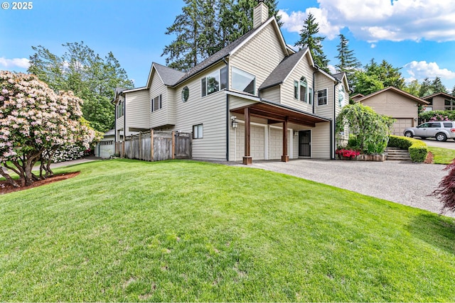 3430 Breezewood Ave, Eugene, OR 97405 - rear view of house with an attached garage, asphalt driveway, and a chimney
