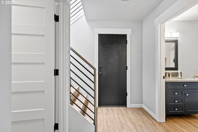 3430 Breezewood Ave, Eugene, OR 97405 - entryway featuring light wood-type flooring, baseboards, and a textured ceiling