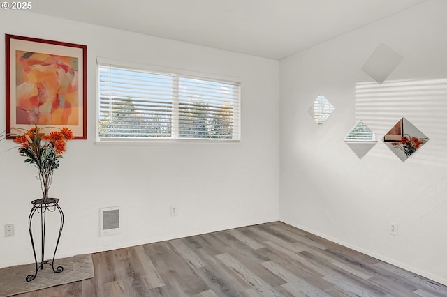 spare room featuring hardwood / wood-style flooring