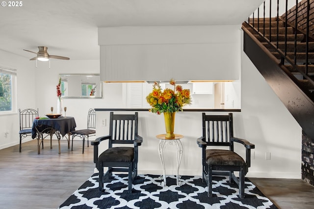 sitting room with ceiling fan and wood-type flooring