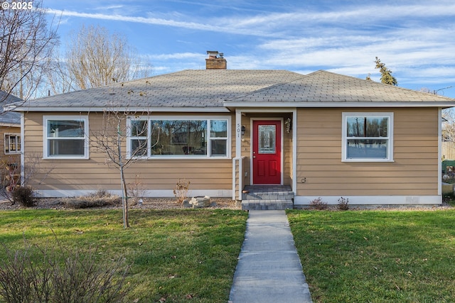 bungalow-style home featuring a front lawn