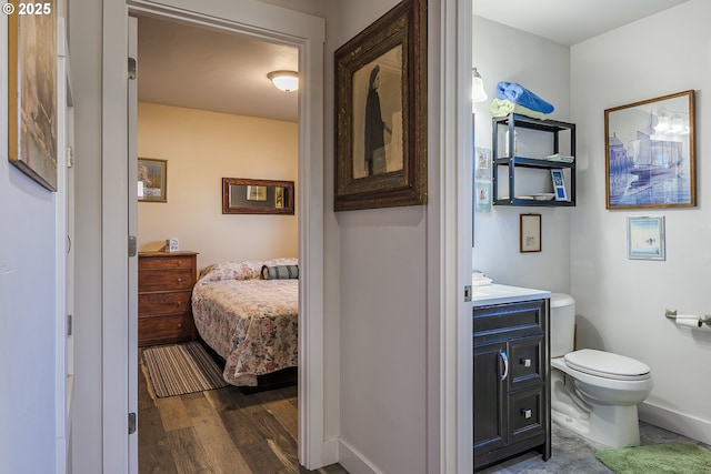 bathroom with vanity, hardwood / wood-style flooring, and toilet