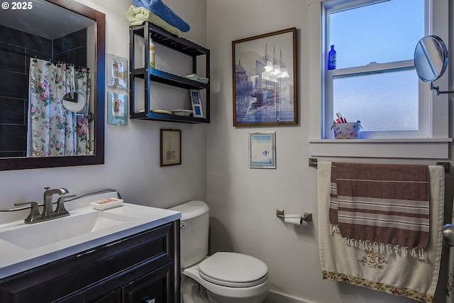 bathroom featuring vanity, a shower with curtain, and toilet