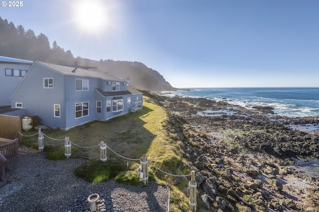 birds eye view of property featuring a water view and a view of the beach