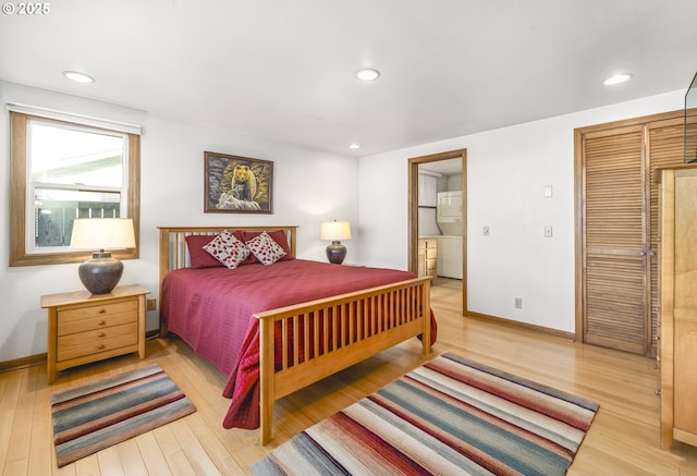 bedroom with hardwood / wood-style flooring, ensuite bathroom, and a closet