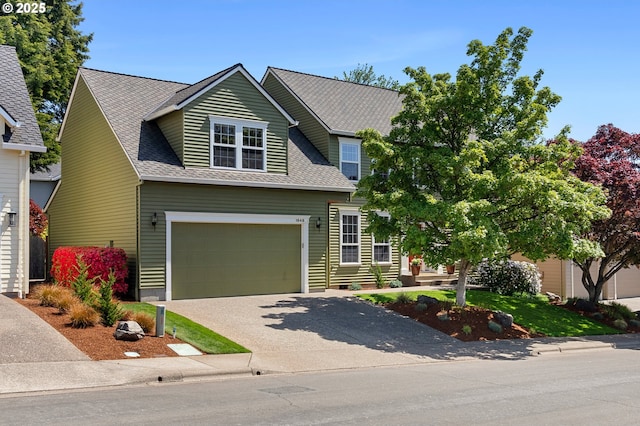 view of front of property featuring concrete driveway, an attached garage, and roof with shingles