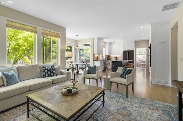 living room featuring wood finished floors and recessed lighting