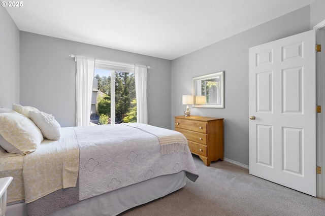 bedroom featuring carpet and baseboards
