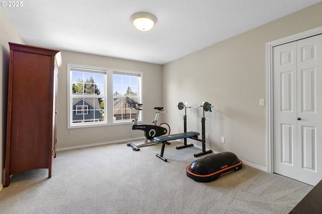 exercise room featuring carpet flooring and baseboards