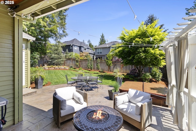 view of patio / terrace featuring outdoor dining area, a residential view, a pergola, and an outdoor living space with a fire pit