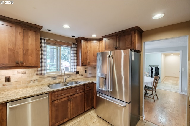 4635 18th Pl S, Salem, OR 97302 - kitchen with stainless steel appliances, a sink, light stone counters, decorative backsplash, and recessed lighting