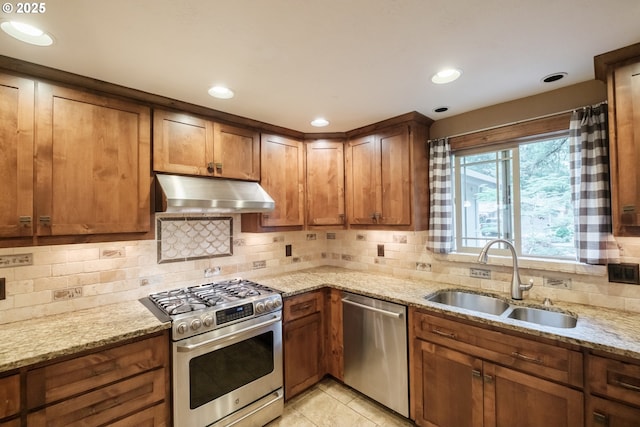 4635 18th Pl S, Salem, OR 97302 - kitchen with appliances with stainless steel finishes, extractor fan, a sink, light stone counters, and decorative backsplash