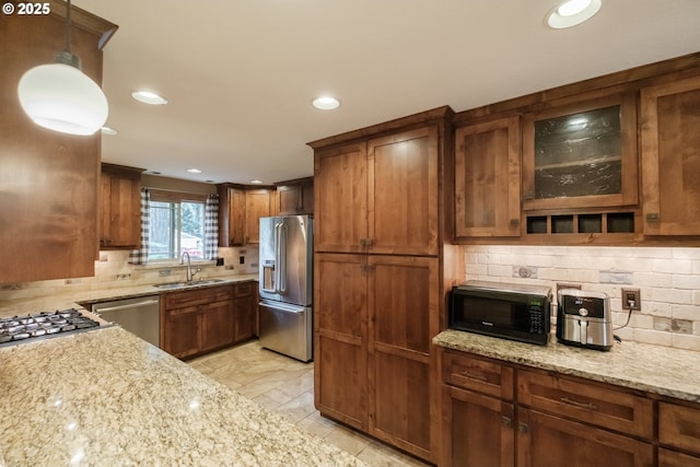 4635 18th Pl S, Salem, OR 97302 - kitchen featuring appliances with stainless steel finishes, a sink, decorative backsplash, recessed lighting, and light stone counters