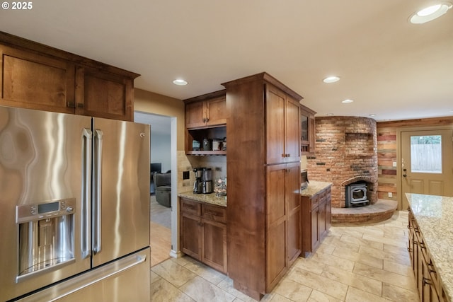 4635 18th Pl S, Salem, OR 97302 - kitchen with stainless steel fridge with ice dispenser, light stone counters, a wood stove, recessed lighting, and brown cabinets