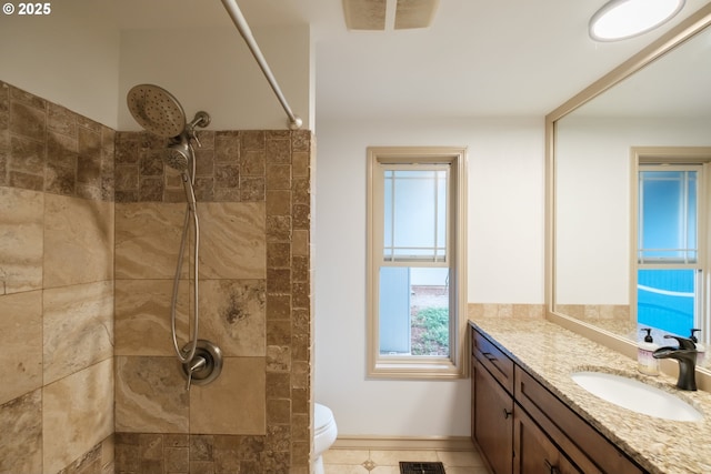4635 18th Pl S, Salem, OR 97302 - bathroom featuring vanity, tiled shower, toilet, tile patterned floors, and baseboards