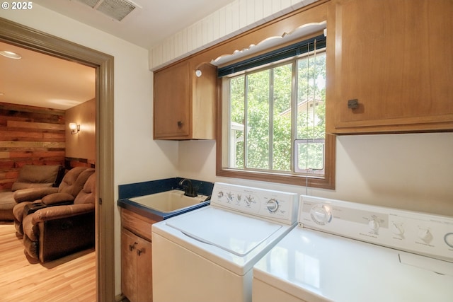 4635 18th Pl S, Salem, OR 97302 - laundry room with washer and clothes dryer, cabinet space, and wood walls